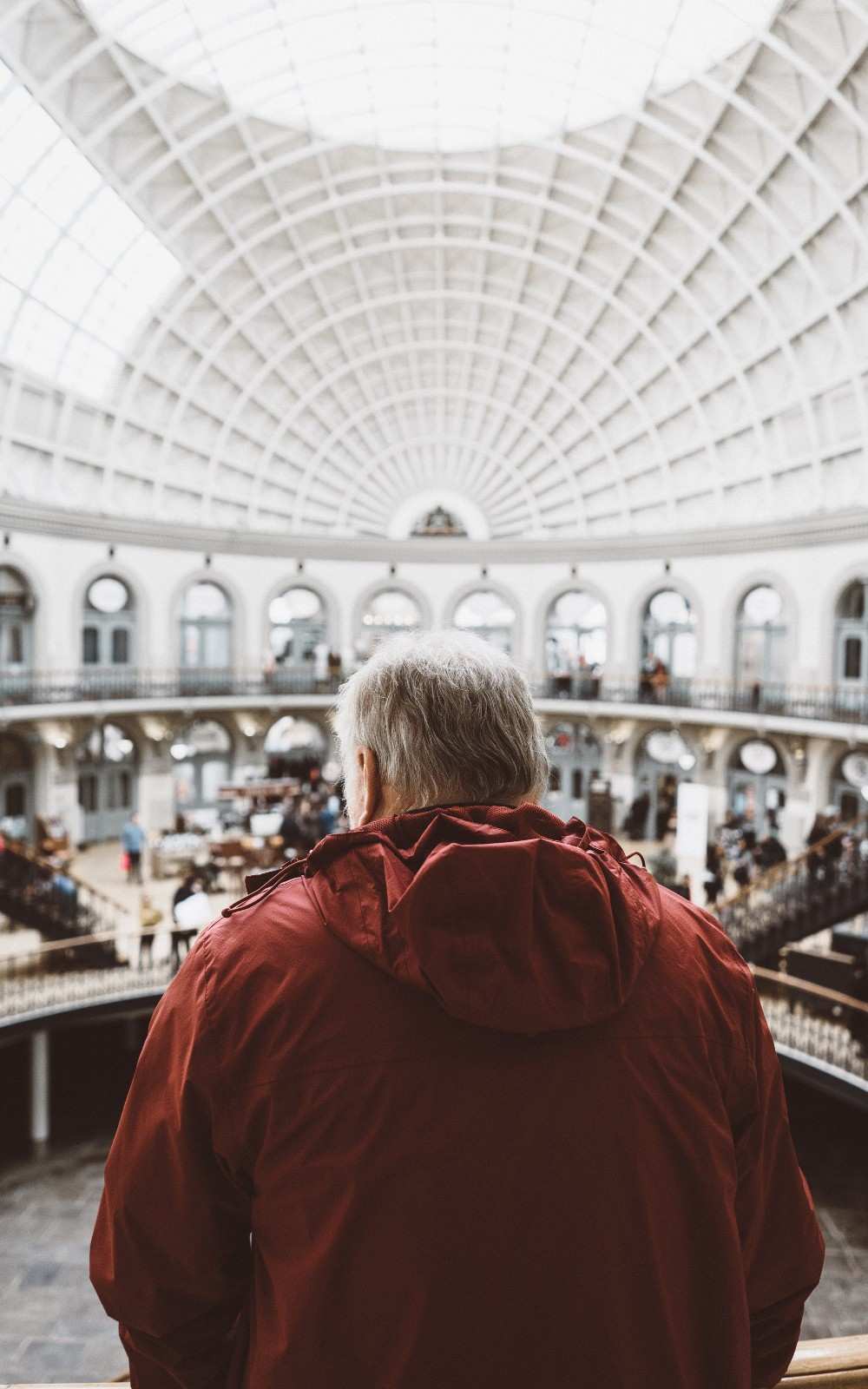 A visitor looking out over the main hall from the second floor.